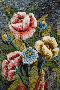 Intricate floral mosaic art featuring pink and yellow flowers with blue accents against a textured stone background