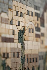 Intricate mosaic artwork featuring a blend of natural stone tiles in earthy tones — a detailed representation of architectural elements