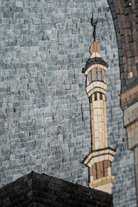 Intricate mosaic artwork featuring a detailed minaret design in shades of gray and beige, showcasing exceptional craftsmanship