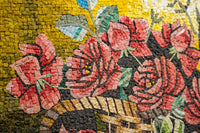 Intricate mosaic artwork featuring vibrant red roses surrounded by lush green leaves on a textured yellow background