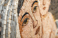 Intricate mosaic artwork featuring a close-up of a woman's face with soft pastel tones and detailed tile textures.