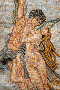 Intricate mosaic artwork depicting a passionate embrace between two figures — vibrant colors highlight their expressions and movement.