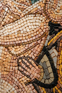 Intricate mosaic artwork featuring warm earth tones and detailed patterns — a stunning display of craftsmanship and texture.