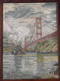 Intricate mosaic artwork depicting the Golden Gate Bridge in muted tones — textured stone pieces create a scenic waterfront view.