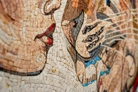 Intricate mosaic artwork featuring stylized faces and flowing lines — warm earthy tones create a captivating visual texture.