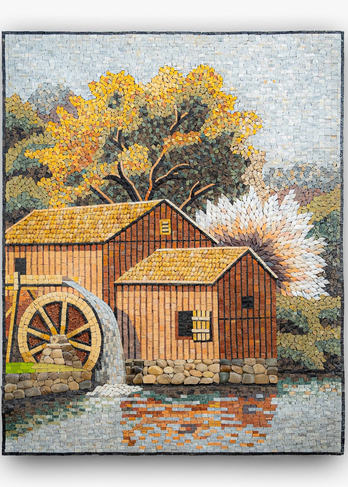 Colorful mosaic artwork depicting a rustic watermill beside a tranquil pond — intricate tiles create a vibrant autumn scene.