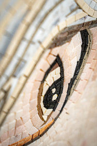 Intricate mosaic artwork featuring a detailed eye design — crafted from colorful stone tiles for a textured finish.
