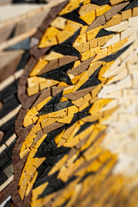 Intricate mosaic art piece featuring a blend of earthy browns, yellows, and blacks — showcasing detailed craftsmanship and texture.