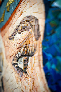 Intricate mosaic artwork featuring a stylized eye with textured tiles in earthy tones and vibrant blues for a striking visual impact.