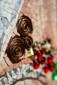 Intricate Default Title featuring copper wire spirals against a textured mosaic background — vibrant red and green embellishments add depth.