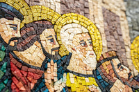 Intricate mosaic artwork depicting figures with vibrant colors and golden halos, showcasing detailed craftsmanship and texture.