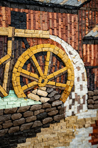 Intricate mosaic artwork featuring a bicycle wheel in earthy tones — crafted with textured tiles for a rustic finish.