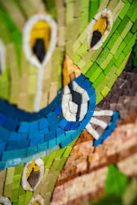 Vibrant mosaic artwork featuring a peacock with blue and green tiles — intricate design showcasing detailed craftsmanship