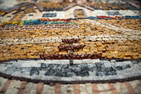 Intricate mosaic artwork featuring a detailed landscape scene with vibrant colors and textured stone tiles.