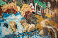Intricate mosaic wall art featuring vibrant sunflowers and a serene river scene — crafted from colorful stone tiles.