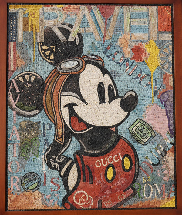 Colorful mosaic artwork featuring a vintage Mickey Mouse in a red outfit with goggles, framed against a textured background.