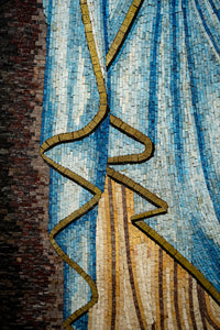Intricate mosaic artwork featuring flowing blue and beige tiles with a wavy gold accent, creating a textured visual appeal.
