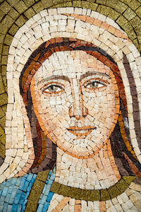 Intricate mosaic artwork depicting a serene face with earthy tones and detailed textures — showcasing artisanal craftsmanship.