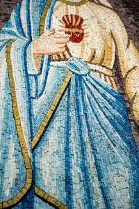 Intricate mosaic artwork depicting a figure in flowing blue robes adorned with golden accents and a vibrant red heart detail.