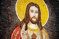 Intricate mosaic artwork depicting Jesus Christ with a golden halo — composed of various colored stone pieces.
