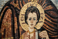 Intricate mosaic artwork depicting a figure with a halo, featuring rich earth tones and detailed craftsmanship that captures light.