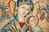 Intricate mosaic art depicting a serene Madonna and child with vibrant blue and gold tiles—capturing a timeless religious scene.