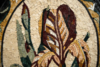 Intricate mosaic wall art featuring stylized leaves in earthy tones of brown, green, and cream with textured tiles.