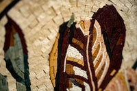 Intricate mosaic art featuring vibrant earth-toned leaves with detailed texture and a glossy finish
