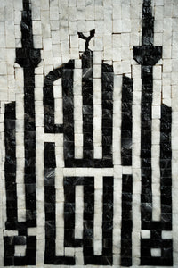 Intricate mosaic artwork featuring a black and white design that resembles a mosque with detailed tile patterns.