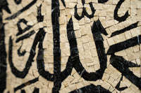 Intricate mosaic art featuring black and cream tiles—decorative craftsmanship with detailed geometric patterns