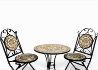 Intricate metal bistro table with hand-painted ceramic top and two matching chairs featuring decorative seat cushions