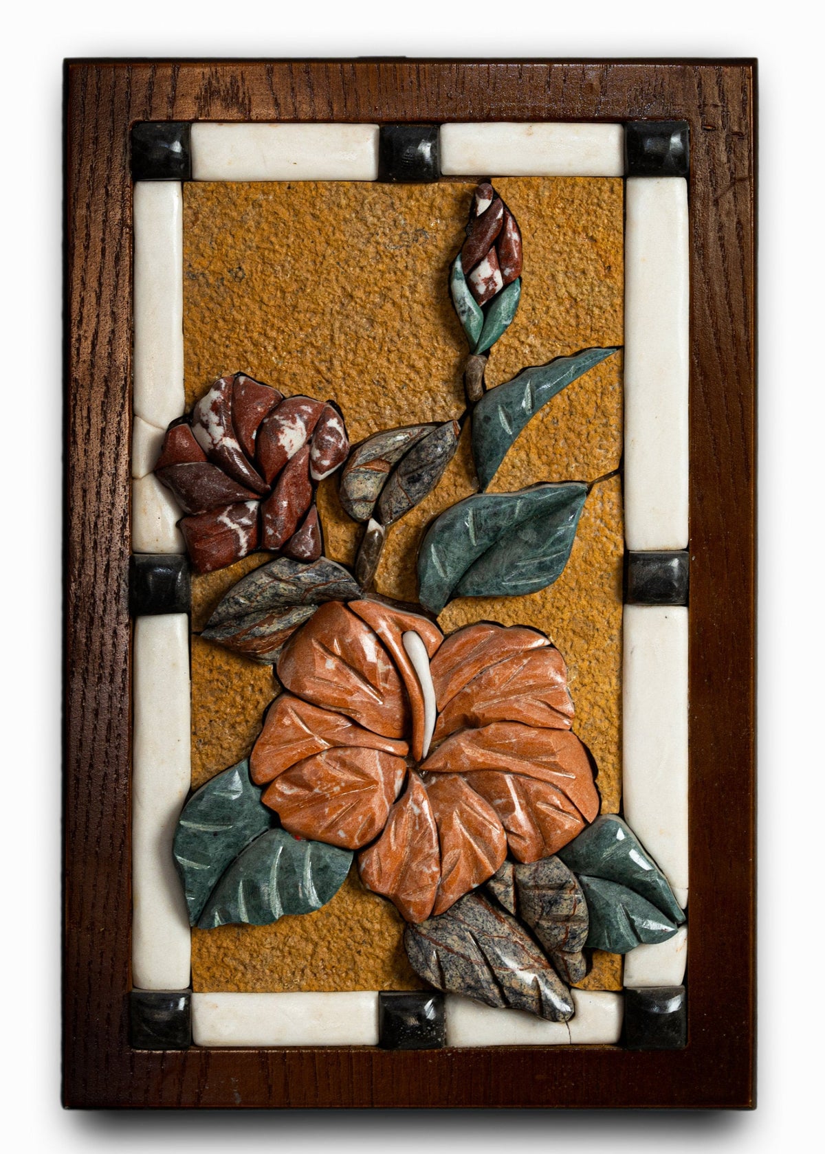 Intricate floral wall art featuring carved hibiscus and rose designs in vibrant orange and rich green against a textured background