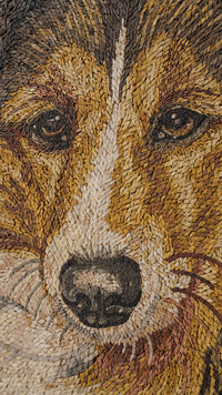 Intricate mosaic artwork depicting a dog's face with warm earthy tones and detailed textures enhancing its expressive features