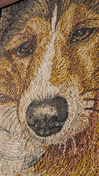 Intricate wooden mosaic art depicting a dog's face with warm tones and detailed textures that capture its expressive eyes