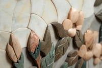 Intricate marble wall art featuring floral designs in earthy tones — a blend of polished and matte finishes.