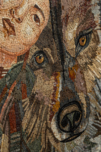 Intricate mosaic artwork featuring a woman's face alongside a wolf's detailed expression — natural stone pieces create depth and texture