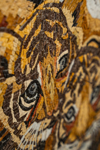 Intricate mosaic artwork featuring tiger faces in warm earth tones — detailed craftsmanship showcasing vibrant textures.