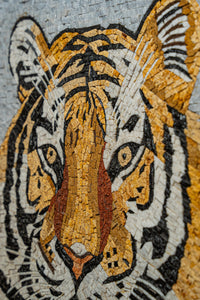 Intricate mosaic art featuring a tiger's face in warm tones of orange and brown with detailed black outlines and textures