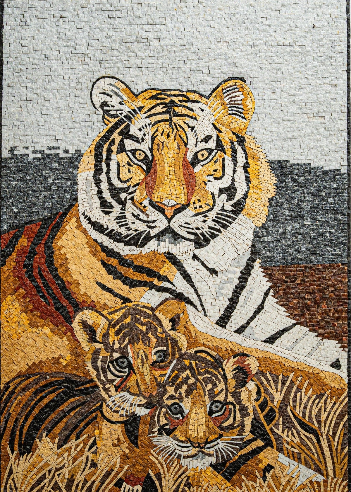 Vibrant mosaic featuring a majestic tiger with two playful cubs nestled in golden grass — intricate details showcase the artistry.