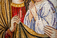 Intricate mosaic artwork featuring textured tiles in warm earth tones—depicting hands in a prayerful gesture.