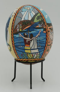 Intricately painted decorative egg featuring vibrant scenes of nature and figures, displayed on a sleek black stand.