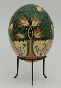 Intricately painted decorative egg featuring vibrant foliage and birds — a unique piece of folk art on a black stand.