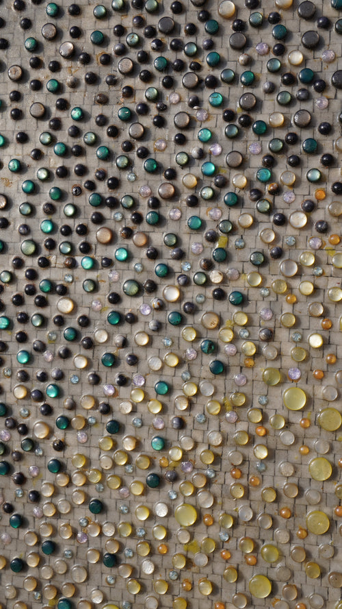 Intricate mosaic wall art featuring a blend of vibrant glass stones in various hues — an eye-catching decorative piece.