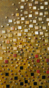 Vibrant mosaic wall art featuring a blend of yellow, orange, and red tiles — intricate design with a glossy finish