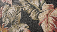 Intricate mosaic artwork featuring large, colorful leaves on a textured stone background — a blend of natural tones and craftsmanship.