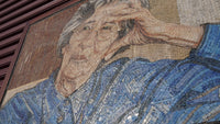 Intricate mosaic artwork depicting an elderly woman in a blue shirt, showcasing detailed textures and vibrant colors.
