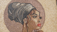 Intricate mosaic artwork featuring a woman's profile with dark hair and striking red lips against a textured stone background