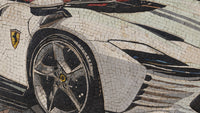 Detailed mosaic artwork featuring a Ferrari car wheel in sleek silver and black tiles — showcasing intricate craftsmanship and design.