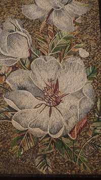 Intricate floral mosaic art featuring large white blossoms with detailed textures and vibrant green leaves against a warm backdrop
