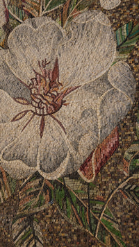 Intricate mosaic floral design featuring a large white flower with detailed textures and vibrant green leaves.